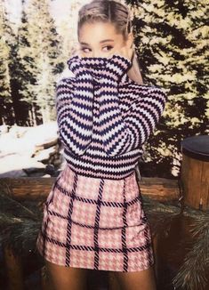 a woman is posing in front of trees with her hands on her face and the words holly shitt above her head