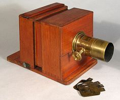 an old fashioned wooden camera with keys on it