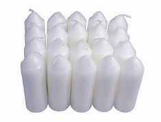 white candles are lined up on a white background