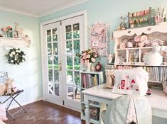 a room filled with lots of furniture and flowers on the wall next to a door