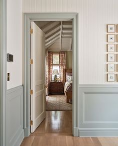 an open door leading to a bedroom with white walls