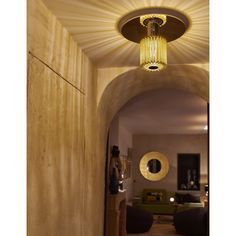 an archway leading to a living room and dining area with round lights hanging from the ceiling