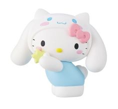 a white and blue hello kitty figurine holding a yellow object in it's hand