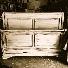 an old white bed frame sitting in a room