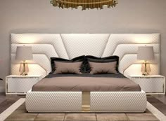 a large bed sitting next to two lamps on either side of the headboard and foot board