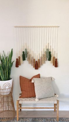 a living room with a couch, rug and wall hanging on the wall that says fossil