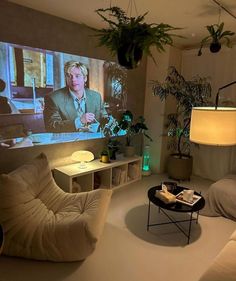 a living room filled with furniture and a flat screen tv mounted to the side of a wall