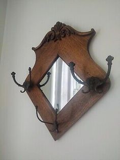 an old wooden mirror hanging on the wall