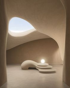 the interior of a building with an oval shaped window and light coming from it's center