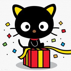 a black cat sitting on top of a red box with a yellow ribbon around it's neck