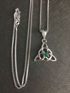 Did you enjoy Charmed, the TV show? I'll fabricate this sterling silver Celtic Trinity Knot pendant, approximately 1 inch in diameter, and I will set your choice of a 6mm round faceted or cabochon gemstone from the drop down menu. This comes with a 16 inch sterling silver box chain at 1.2mm thickness with a lobster claw for secure attachment. This is shown with a classic green Lab emerald faceted gemstone for the lucky lass in you! It's lovely, graceful and elegant...a timeless and classic tradi White Gold Emerald Necklace In Sterling Silver As Gift, Silver Emerald Gemstone Necklace, Spiritual Sterling Silver Necklace For May Birthstone, Fine Jewelry Silver Necklace For May Birthstone, Silver Fine Jewelry Necklace For May Birthstone, Spiritual Sterling Silver Birthstone Necklace With Gemstone, Hallmarked Silver Sterling Silver Emerald Necklace, Silver Sterling Silver Hallmarked Emerald Necklace, Hallmarked Sterling Silver Emerald Necklace