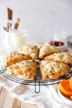 several scones on a cooling rack with orange slices