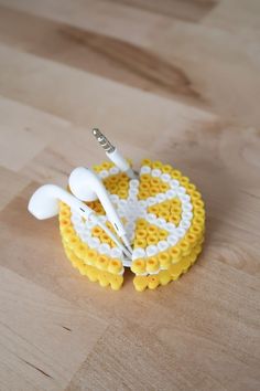 two white and yellow objects sitting on top of a wooden table