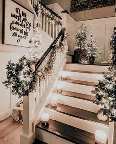 stairs decorated with christmas lights and greenery for the holiday decorations on each handrail