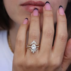 a close up of a person with a ring on their finger and her hand in front of her face