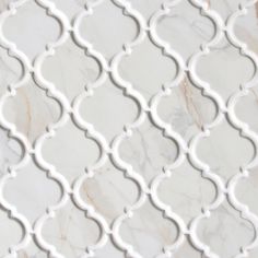 a white marble tile with an intricate design