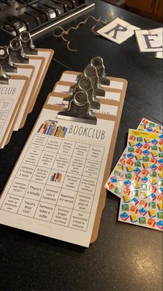 three bookclub clipboards sitting on top of a table