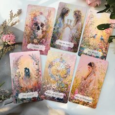 four cards with images of women and flowers on them, one has a skull in the middle