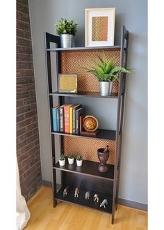 a book shelf with books and plants on it