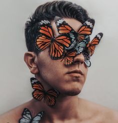 a man with many butterflies on his face