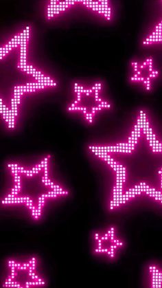 several pink stars are shown in the dark