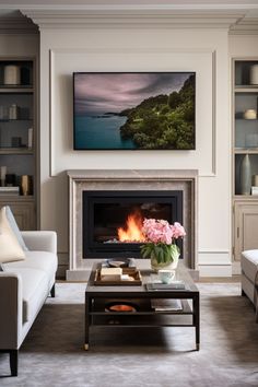 a living room with two couches and a fire place in it's center