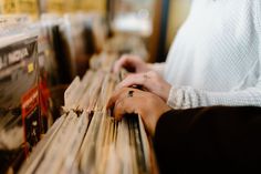 a person with their hand on a record player