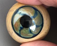 an eyeball is being held in someone's hand