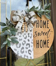 a door hanger that says home sweet home with a leopard print bow and wooden beads