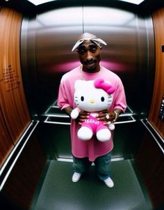 a man holding a hello kitty stuffed animal