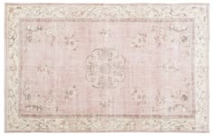 an antique rug with flowers and scrolls on the bottom, in light pink tones against a white background