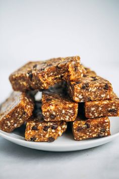 a plate full of granola bars on a white tablecloth with the top cut off