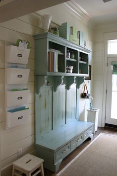 a room with a bench and shelves on the wall