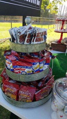 a table topped with lots of food and candy bar bags on top of each other