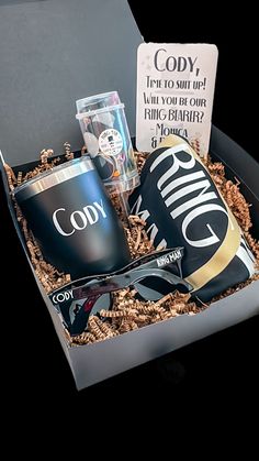 an open box with sunglasses, coffee mug and card in it that says gody