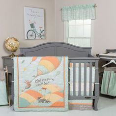 a baby's nursery room with a crib, bedding and other items