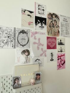 the wall is covered with many different pictures and posters, including one woman's face