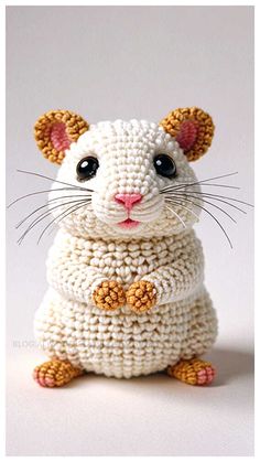 a crocheted rat sitting on its hind legs