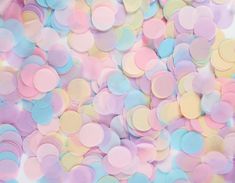 pastel colored confetti scattered over white background