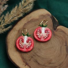 two pieces of fruit are sitting on a wooden plate