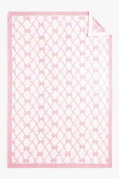 a pink and white scarf with bows on the front, against a white background that has a light pink border