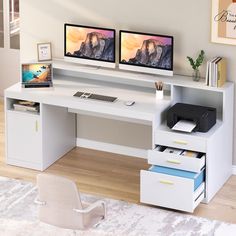 two computer monitors sitting on top of a white desk