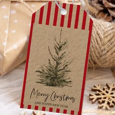 a christmas gift tag with a pine tree on it next to twine of twine