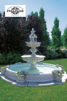 a water fountain in the middle of a lawn