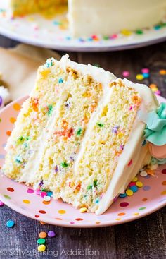 a slice of cake on a plate with sprinkles