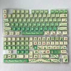 a green and white computer keyboard sitting on top of a table