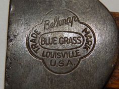 a close up of a metal object with writing on the side and an american flag in the background