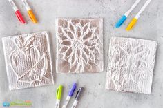 some crochet doily and markers are laying on the table next to each other