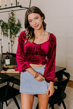 - Show off your flair for fashion with this luxe top! Its flattering design and sweet ruffle detailing make it the perfect piece to elevate a trendy OOTD. Get ready to turn heads in this stunning top! - Unlined velvet material - A wide v-cut neckline with an accent bow - Long sleeves with elastic shoulders and elastic cuffs - Faux buttoned front accents - A corset style design - A flattering silhouette that ends in a ruffled crop hemline Chic Burgundy Tops For Party, Elegant Velvet Tops For Fall, Velvet Blouse For Party, Chic Velvet Tops For Fall, Burgundy Top For Fall Party, Burgundy Tops For Fall Party, Fall Party Burgundy Top, Velvet Tops For Fall Night Out, Chic Burgundy Party Top