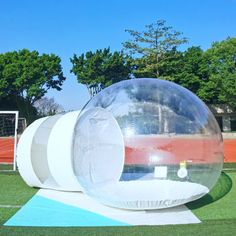 an inflatable ball sitting on top of a soccer field